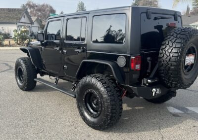 a black jeep with large tires