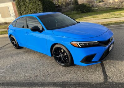 a blue car parked on a driveway